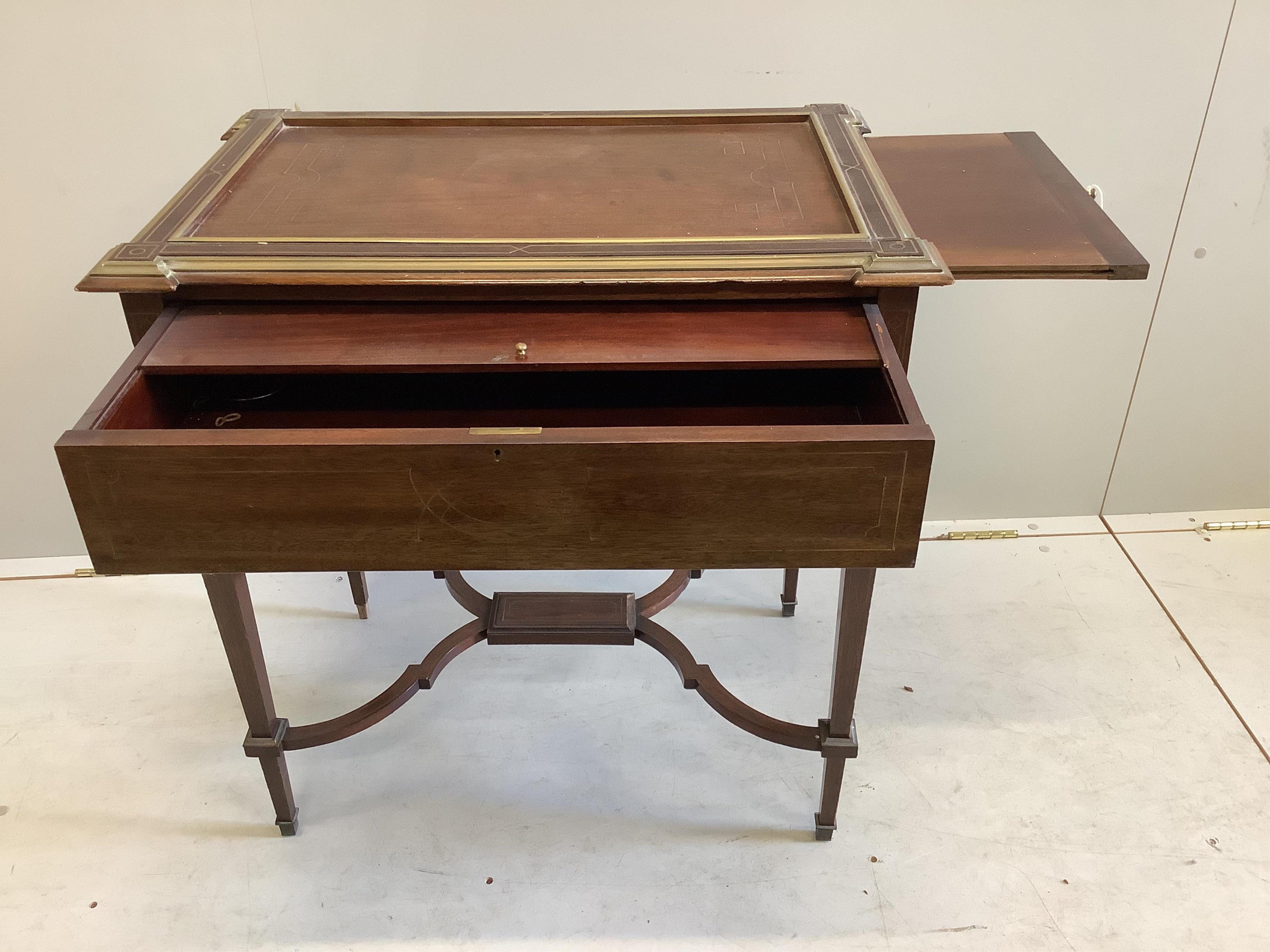 A 19th century French Empire mahogany writing table with gilt brass inlay, frieze drawer with fitted interior and twin pull-out candle slides, on square tapered legs and cross stretchers, width 71cm, depth 47cm, height 7